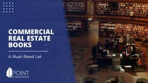 a commercial real estate books in a library with a man sitting at a desk