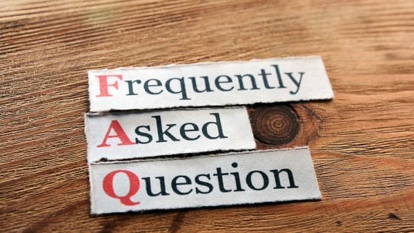 Newspaper cutouts spelling 'Frequently Asked Question' on a wooden surface, indicating a section for queries on 'accumulated depreciation'.
