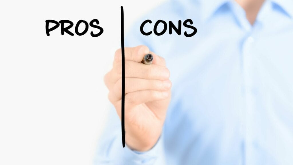 A person in a light blue shirt is drawing a vertical line on a clear surface to create two columns, with "PROS" written on the left and "CONS" on the right, symbolizing a comparison of the advantages and disadvantages of choosing a Modified Gross Lease. The focus is on the hand holding the marker, with a blurred background enhancing the clarity of the handwritten text.