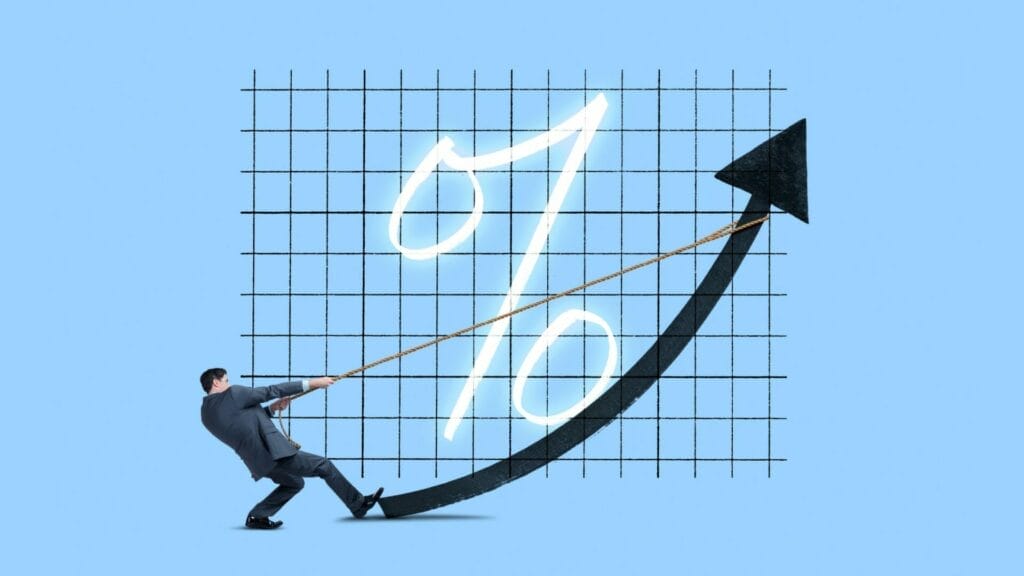 A businessman pulls down a graph trend line with a rope to keep it stable, representing the concept of 'Keeping the Same Interest Rate When Refinancing Commercial Real Estate (CRE),' set against a light blue background.