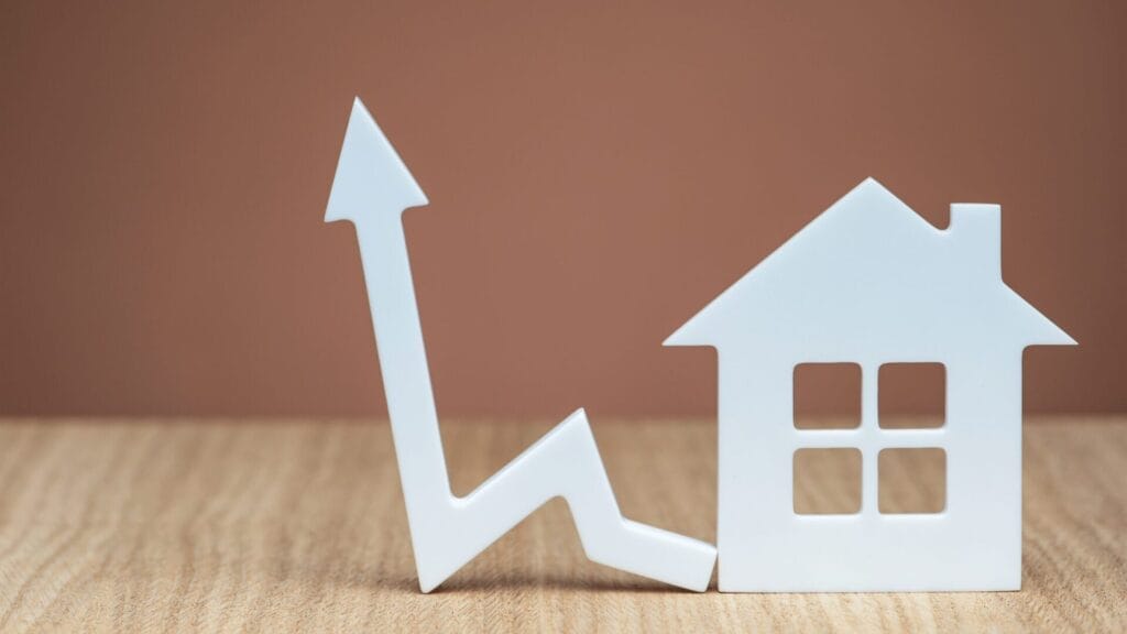 Graph showing upward trends with a house symbol, representing property market growth.